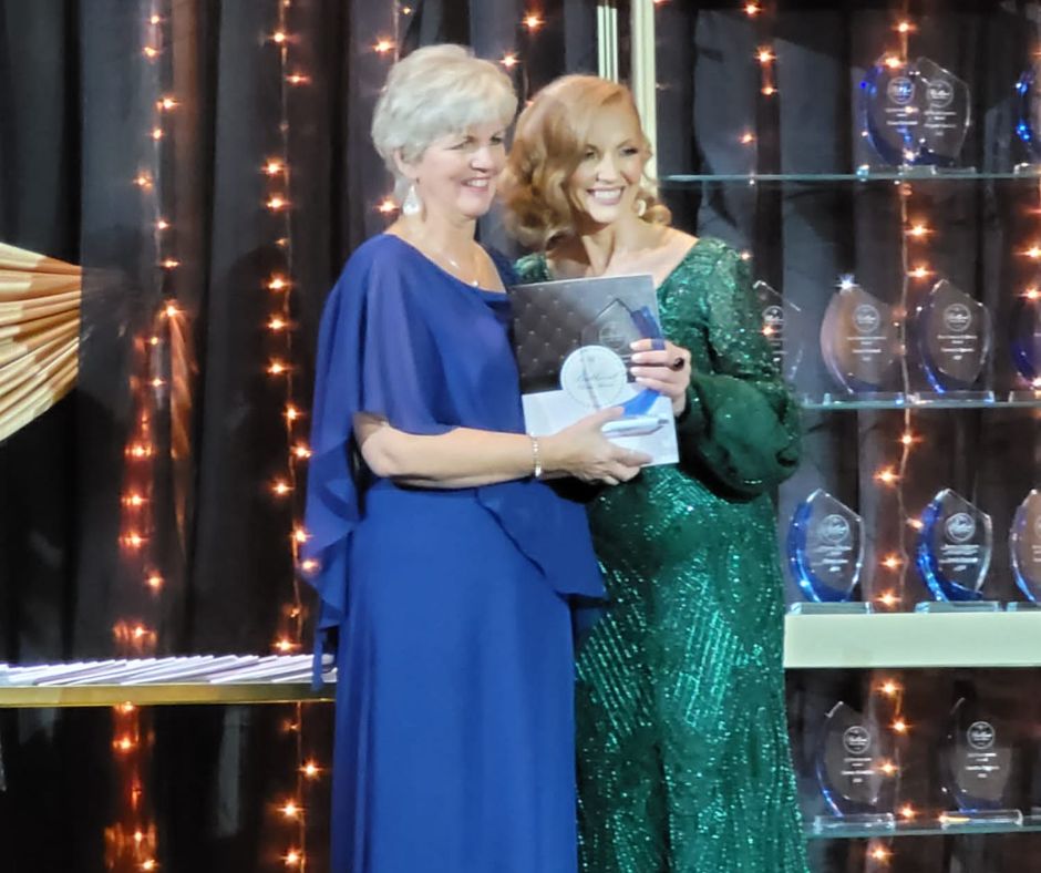 Lila receiving the award from Founder Agata